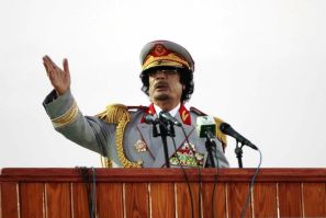 Libyan leader Moammar Gadhafi speaks during a ceremony to mark the 40th anniversary of the evacuation of the American military bases in the country, in Tripoli
