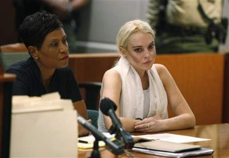 Actress Lindsay Lohan (R), with her attorney Shawn Holley, sits during a progress report hearing at Airport Branch Courthouse in Los Angeles