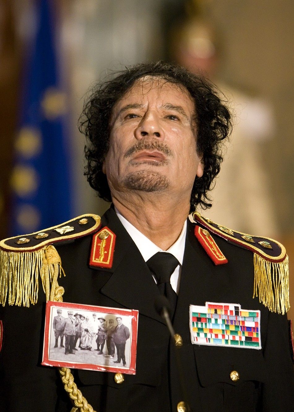 Muammar Gaddafi looks on during a news conference at the Quirinale palace in Rome 2009