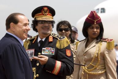 Muammar Gaddafi and Italy&#039;s Prime Minister Silvio Berlusconi leave Ciampino Airport in Rome June 10, 2009