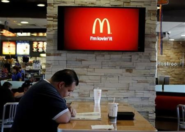 Customer Steven Price sits at a table near a HDTV screen showing the new McDonald&#039;s Channel