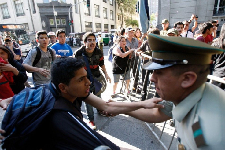 Demonstrators clash with riot police during a protest in Santiago