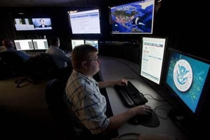 Analysts work in a watch and warning center of a cyber security defense lab at the Idaho National Laboratory in Idaho Falls, Idaho