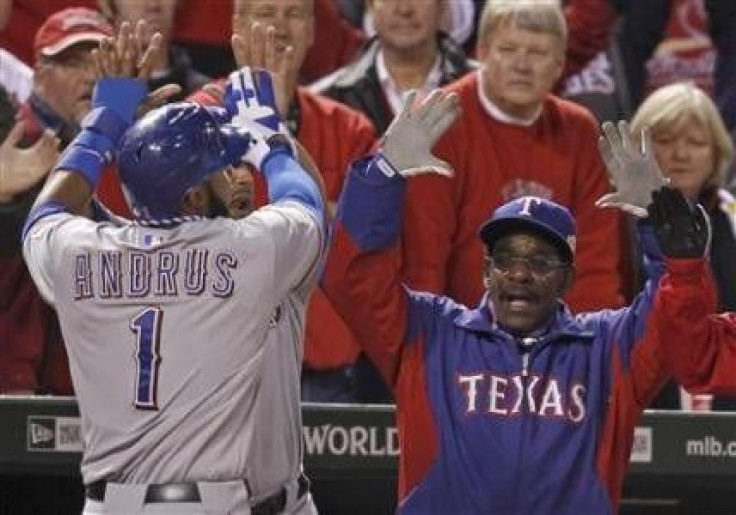 Texas Rangers&#039; Elvis Andrus (L) is congratulated by manager Ron Washington after scoring his team&#039;s second run against the St. Louis Cardinals during the ninth inning in Game 2 of MLB&#039;s World Series baseball championship in St. Louis, Misso