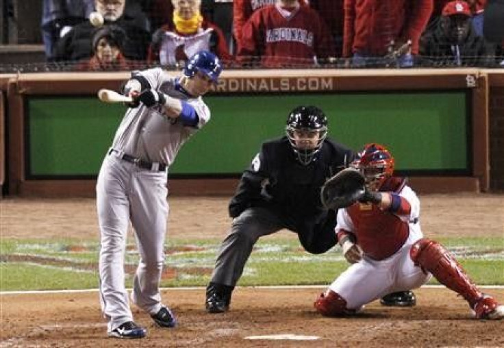 Texas Rangers left fielder Josh Hamilton hits a sacrifice RBI against the St. Louis Cardinals to tie the game in the ninth inning in Game 2 of MLB's World Series baseball championship in St. Louis, Missouri