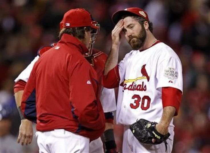 St. Louis Cardinals relief pitcher Jason Motte (R) reacts as manager Tony La Russa takes him from the game in the ninth inning of play against the Texas Rangers in Game 2 of MLB&#039;s World Series baseball championship in St. Louis, Missouri