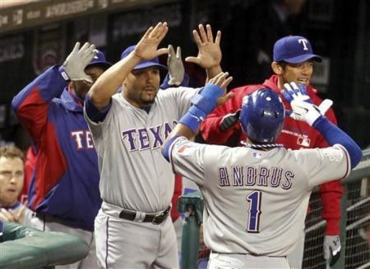Texas Rangers shortstop Elvis Andrus celebrates with Yorvit Torrealba (L) after scoring the game winning run against the St. Louis Cardinals in the ninth inning in Game 2 of World Series baseball championship in St. Louis, Missouri