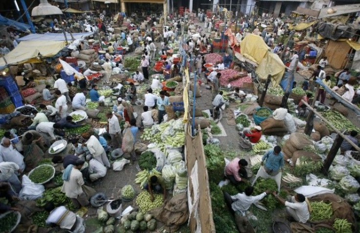 People buy vegetables at a wholesale market in New Delhi April 15, 2010. India's September wholesale price index 8.62 percent, a government data showed on Friday.