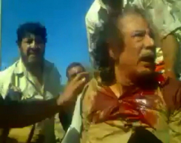 Frame grab shows former Libyan leader Muammar Gaddafi, covered in blood, after his capture by NTC fighters in Sirte