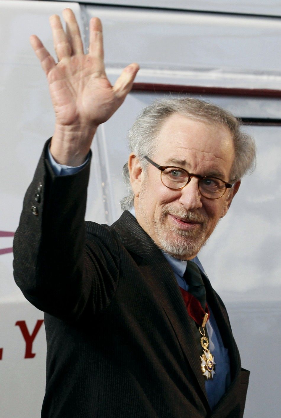 Director Steven Splielberg waves during the launch of a Tintin Thalys high-speed train in Brussels