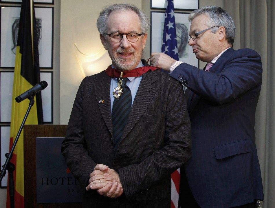 Director Steven Spielberg L receives his Commander of the Order of the Crown decoration from Belgiums Finance Minister Didier Reynders during a ceremony ahead of the world premiere of the movie quotThe Adventures Of Tintin The Secret of The Unicorn