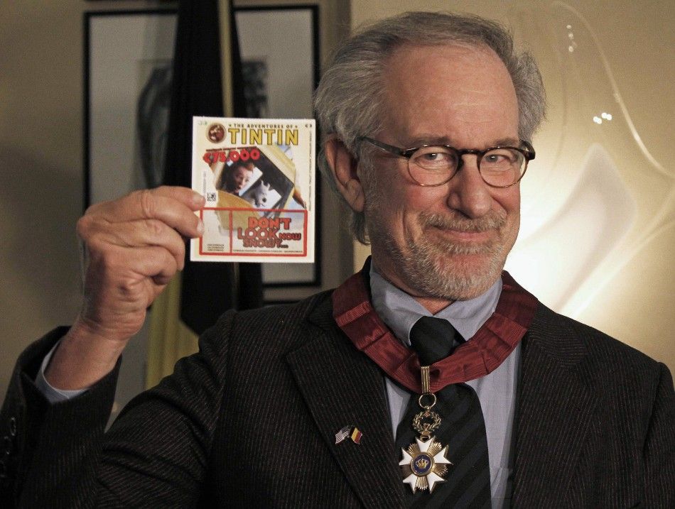 Director Steven Spielberg shows a Tintin lottery ticket during a ceremony ahead of the world premiere of his movie quotThe Adventures Of Tintin The Secret of The Unicornquot in Brussels October 22, 2011.
