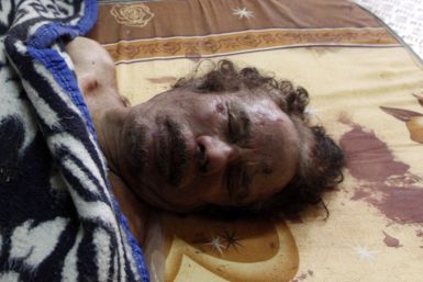 Dead body of Gaddafi is displayed inside a metal storage freezer in Misrata