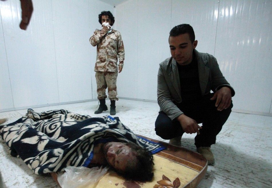 The body of Muammar Gaddafi is seen inside a cold metal storage container in Misrata
