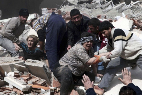 Rescue workers rescue people trapped under debris after an earthquake in a village near the eastern Turkish city of Van