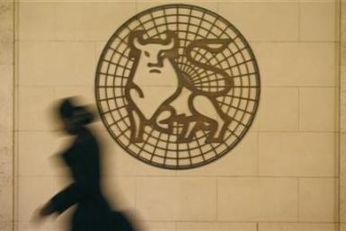 A woman walks past the Merrill Lynch logo outside their offices in the City of London