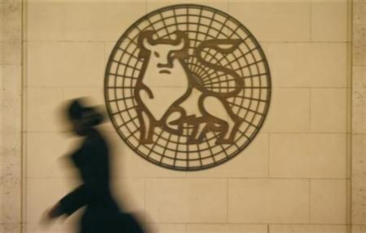 A woman walks past the Merrill Lynch logo outside their offices in the City of London