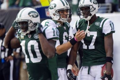 Mark Sanchez connects with Plaxico Burress for three TDs.