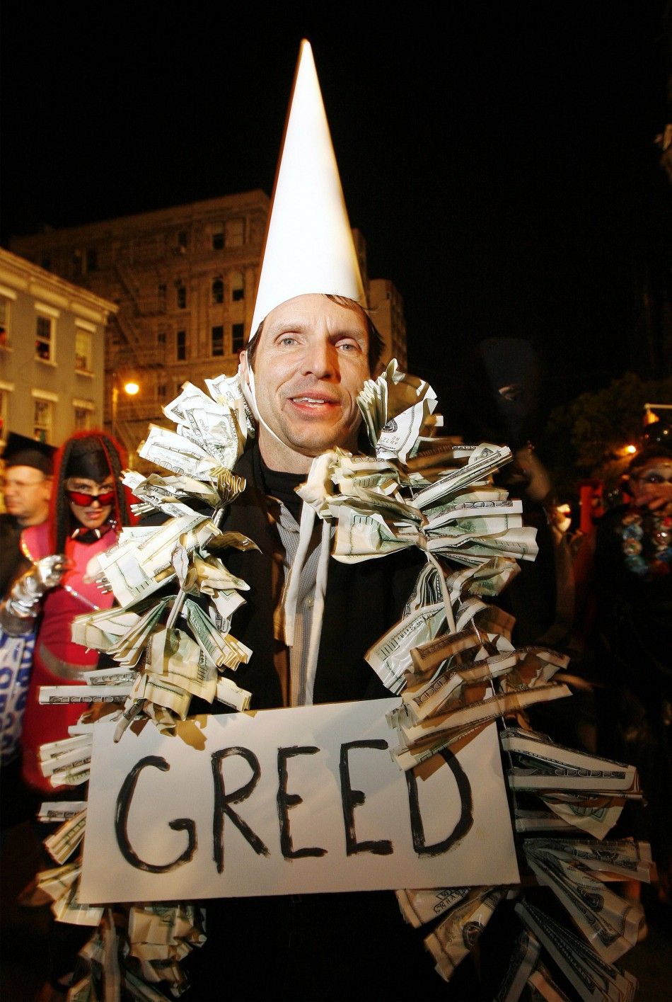 Revelers dressed in financial themed costumes march in the annual Greenwich Village Halloween Parade in New York, October 31, 2008. 