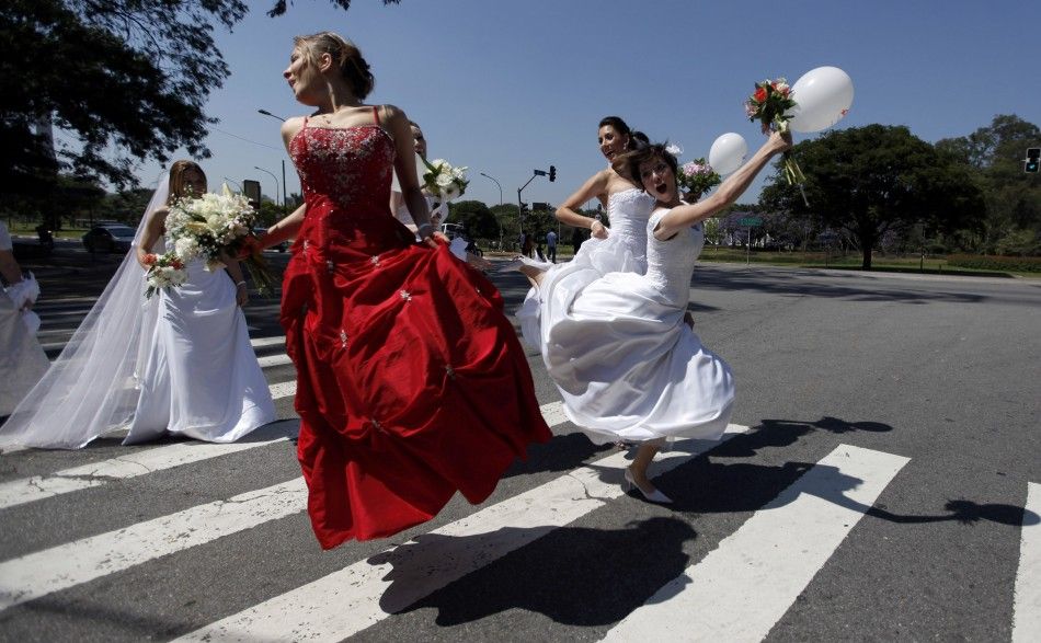 Women in wedding gowns jump on the street during a quotParade of Bridesquot in Sao Paulo 