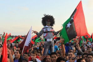 Libyan people with the Kingdom of Libya flags gather during celebrations for the liberation of Libya in Quiche, Benghazi October 23, 2011