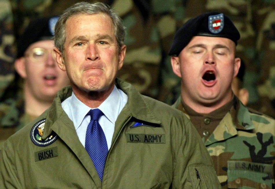 U.S. President George W. Bush listens as U.S. Army soldiers sing quotThe Army Songquot during a stop at Fort Hood, Texas, January 3, 2003. Bush addressed the soldiers and their families about the possiblity of military action against Iraq.