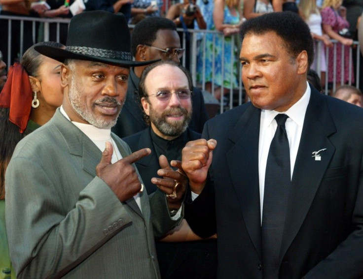 Boxers Joe Frazier (L) and Muhammad Ali pose together as they arrive at the 10th annual ESPY Awards in 2002.