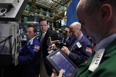 Traders work on the floor of the New York Stock Exchange October 21, 2011.
