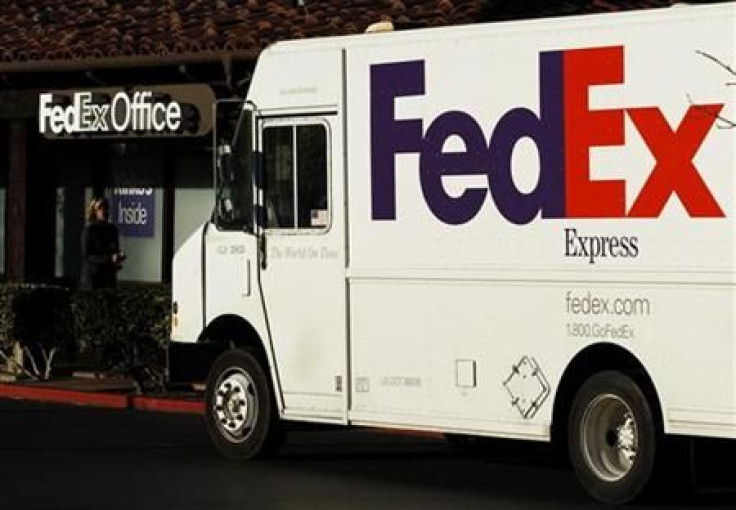 A Federal Express trucks loads packages at one of the company&#039;s FedEx Office outlets in Encinitas
