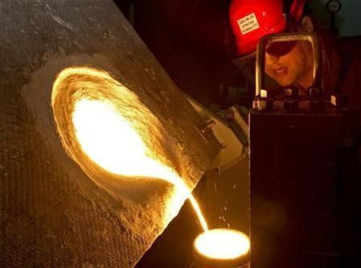 A worker casts an ingot of platinum