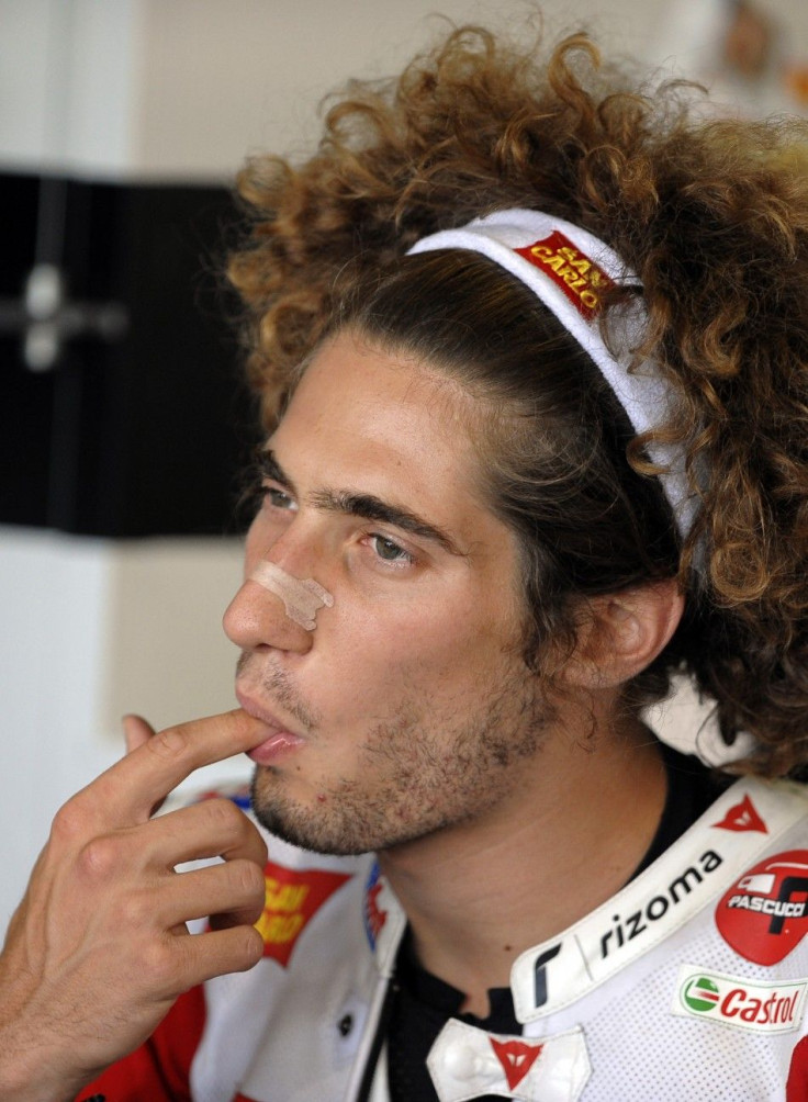 Honda MotoGP rider Simoncelli of Italy puts his finger into his mouth before first free practice session of San Marino motorcycling Grand Prix at Misano circuit