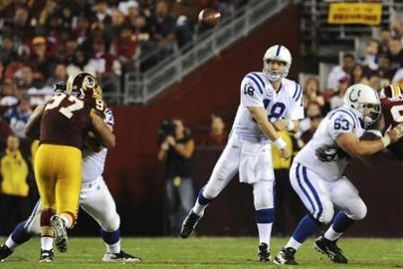 Indianapolis Colts quarterback Peyton Manning 18 passes against the Washington Redskins during the second half of their NFL football game in Landover, Maryland, October 17, 2010.