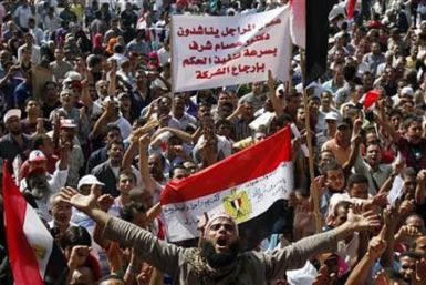Protesters chant slogans against the government and military rulers at Tahrir Square after Friday prayers in Cairo
