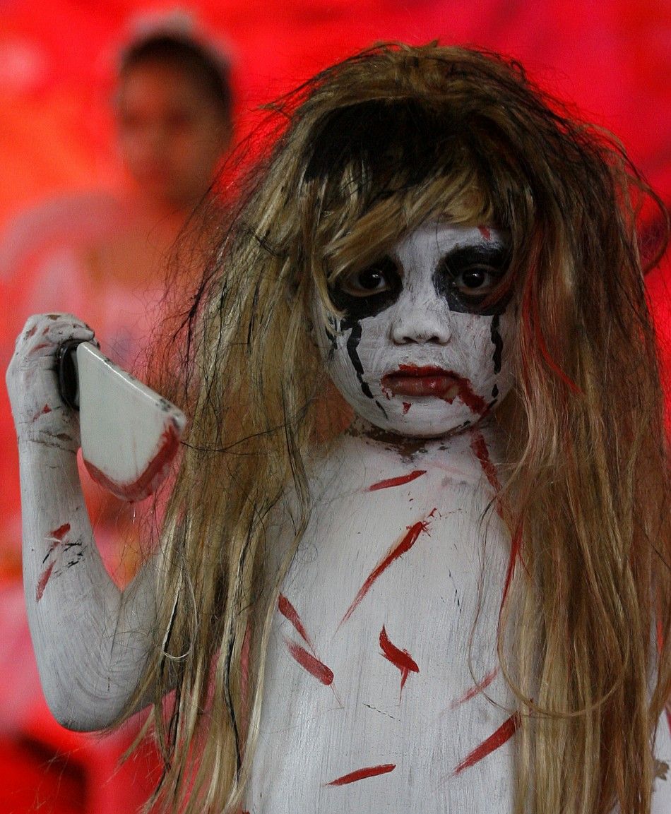 A girl models her costume during the kids costume competition at the quotScaredy Cats and Dogsquot Halloween fund-raising event at a mall in Quezon City, Metro Manila, October 23, 2011. Some 100 pets participated in the event to raise funds for the Ph