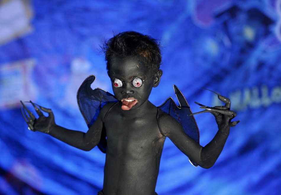 A boy models his monster costume during the kids costume competition at the quotScaredy Cats and Dogsquot Halloween fund-raising event at a mall in Quezon City, Metro Manila, October 23, 2011.