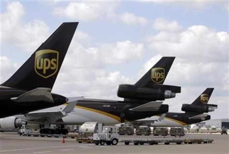 UPS employees load containers onto aircraft at World Port air hub during visit by U.S. Treasury Secretary Geithner in Louisville