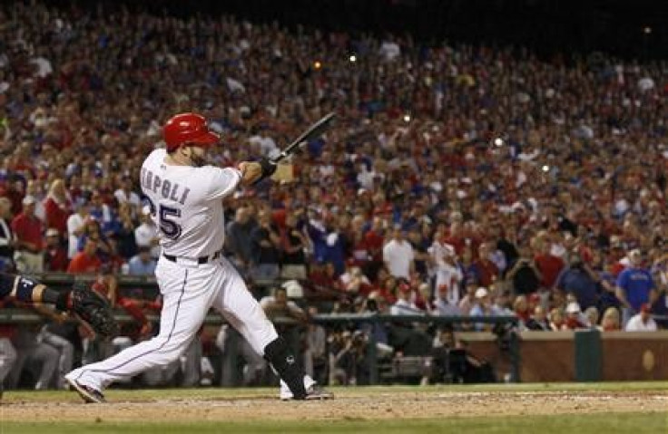 Texas Rangers&#039; Mike Napoli hits a two-RBI double against the St. Louis Cardinals in the eighth inning of Game 5 of MLB&#039;s World Series baseball championship in Arlington, Texas