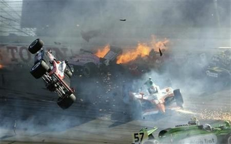 The race car of driver Will Power (L) goes airborne during the IZOD IndyCar World Championship race at the Las Vegas Motor Speedway in Las Vegas, Nevada