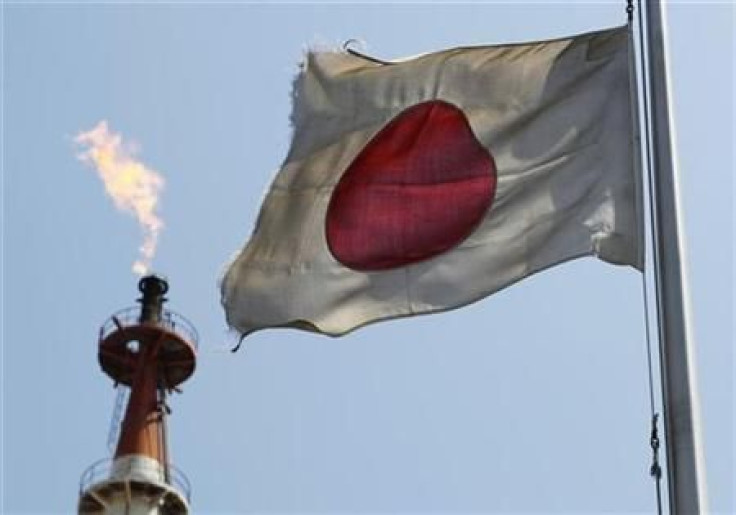 A Japanese national flag flutters near a gas flare from a factory at Keihin industrial zone in Kawasaki in this file photo.