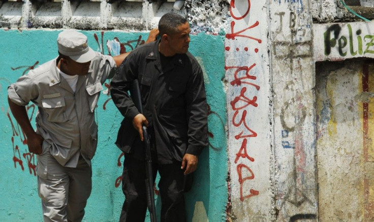 Police officers keep watch on protestors during a nationwide strike in Santo Domingo