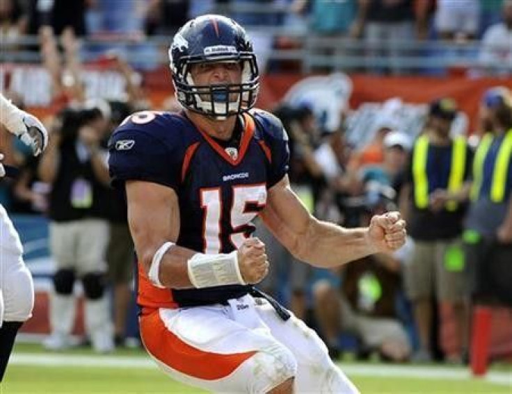 Denver Broncos&#039; quarterback Tim Tebow celebrates after running the ball in for a two-point conversion to tie the score in the fourth quarter of play against the Miami Dolphins in their NFL football game in Miami, Florida