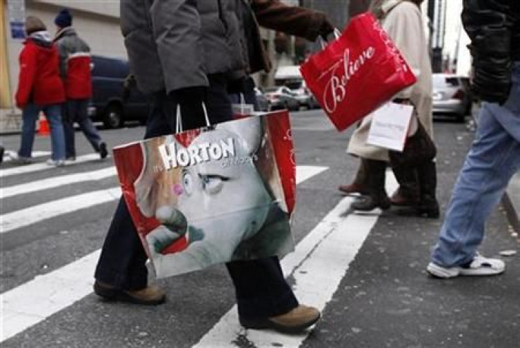 Shoppers carry bags as they walk down Fifth Avenue in New York