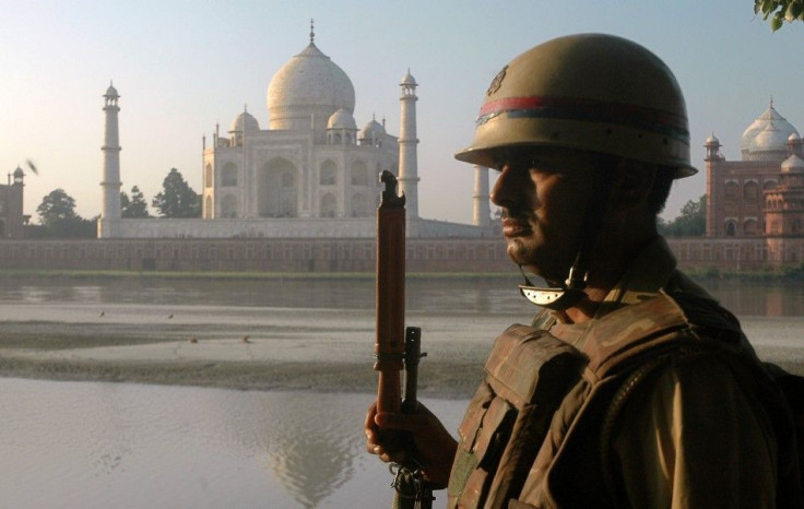 A policeman keeps vigil on the banks of river Yamuna in front of historic Taj Mahal