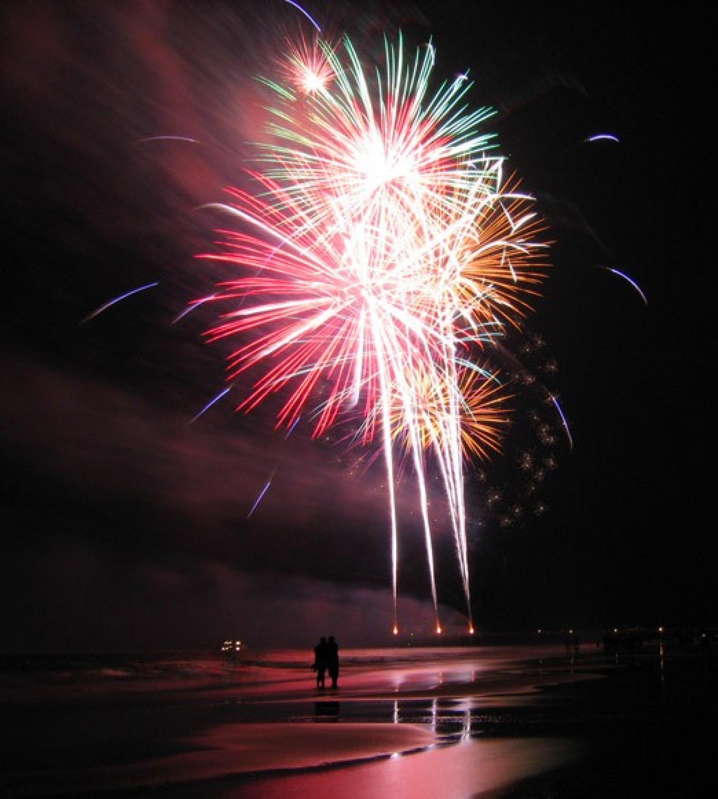 A collection of palm-shell fireworks illuminating the beach of Tybee Island, Georgia.