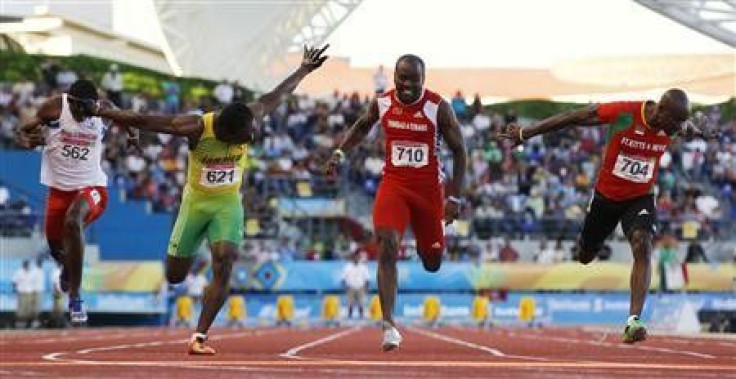 Jamaica&#039;s Lerone Clarke (2nd L) crosses the finish line ahead of Kim Collins (R) of Saint Kitts and Nevis, Emmanuel Callender of Trinidad and Tobago (2nd R) and Jorge Rafael of the Dominican Republic during the men&#039;s 100m final at the Pan Americ