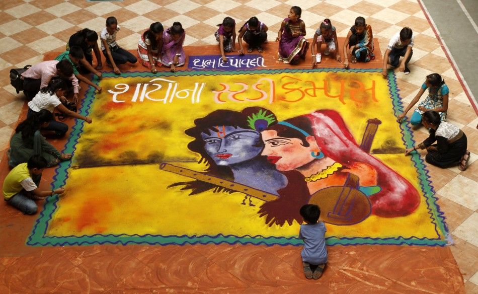 Students put finishing touches to a quotrangoliquot, or mural made out of coloured powders, at a school ahead of Diwali festival celebrations in Ahmedabad on October 21, 2011.