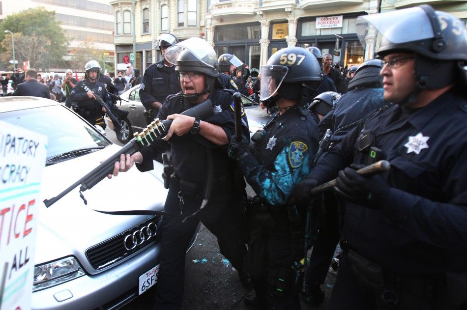Police officers reconnect with a group of stranded colleagues during an Occupy Wall St. demonstration in Oakland