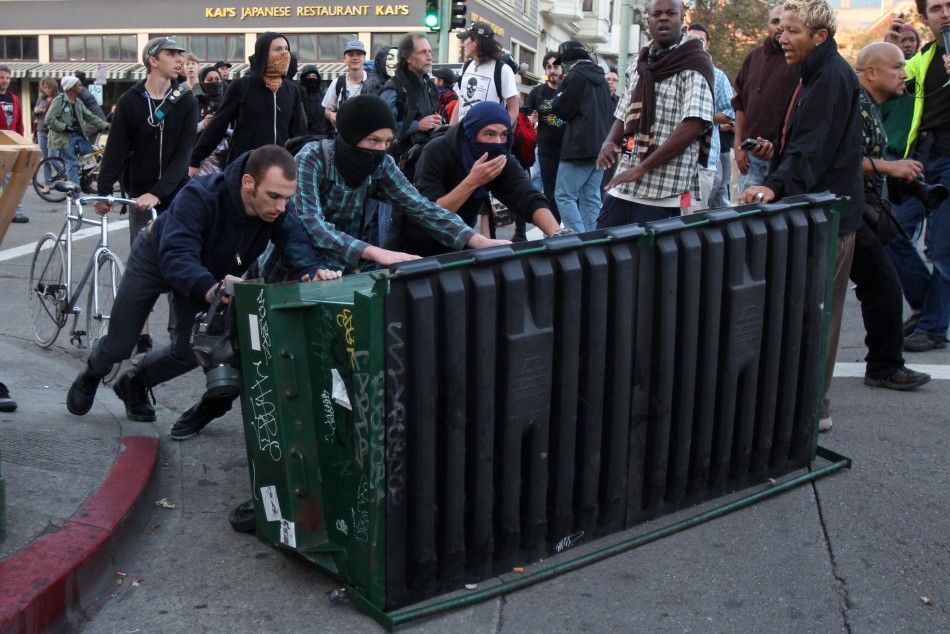 A group of quotOccupy Wall Streetquot demonstrators pushes a garbage container toward a line of police officers during a demonstration in Oakland