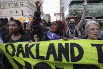 A group of &quot;Occupy Wall Street&quot; demonstrators hold a banner in Oakland