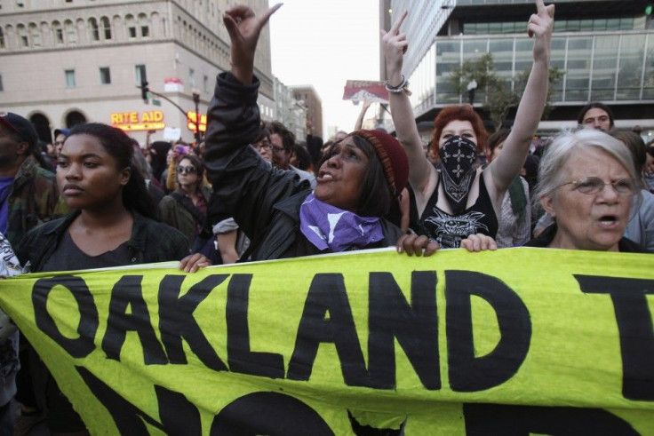 A group of &quot;Occupy Wall Street&quot; demonstrators hold a banner in Oakland